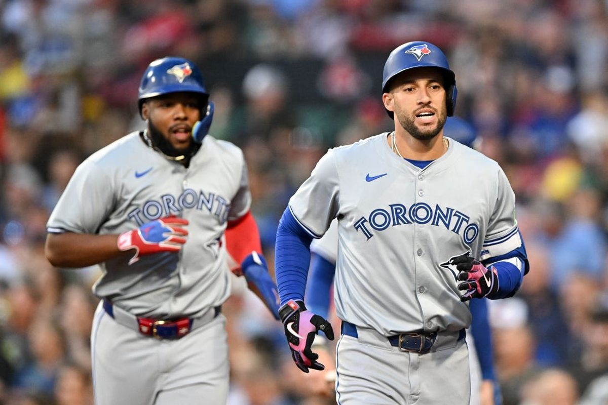 Jun 25, 2024; Boston, Massachusetts, USA; Toronto Blue Jays right fielder George Springer (4) and first baseman Vladimir Guerrero Jr. (27) run to the dugout after scoring against the Boston Red Sox during the third inning at Fenway Park. Mandatory Credit: Brian Fluharty-USA TODAY Sports