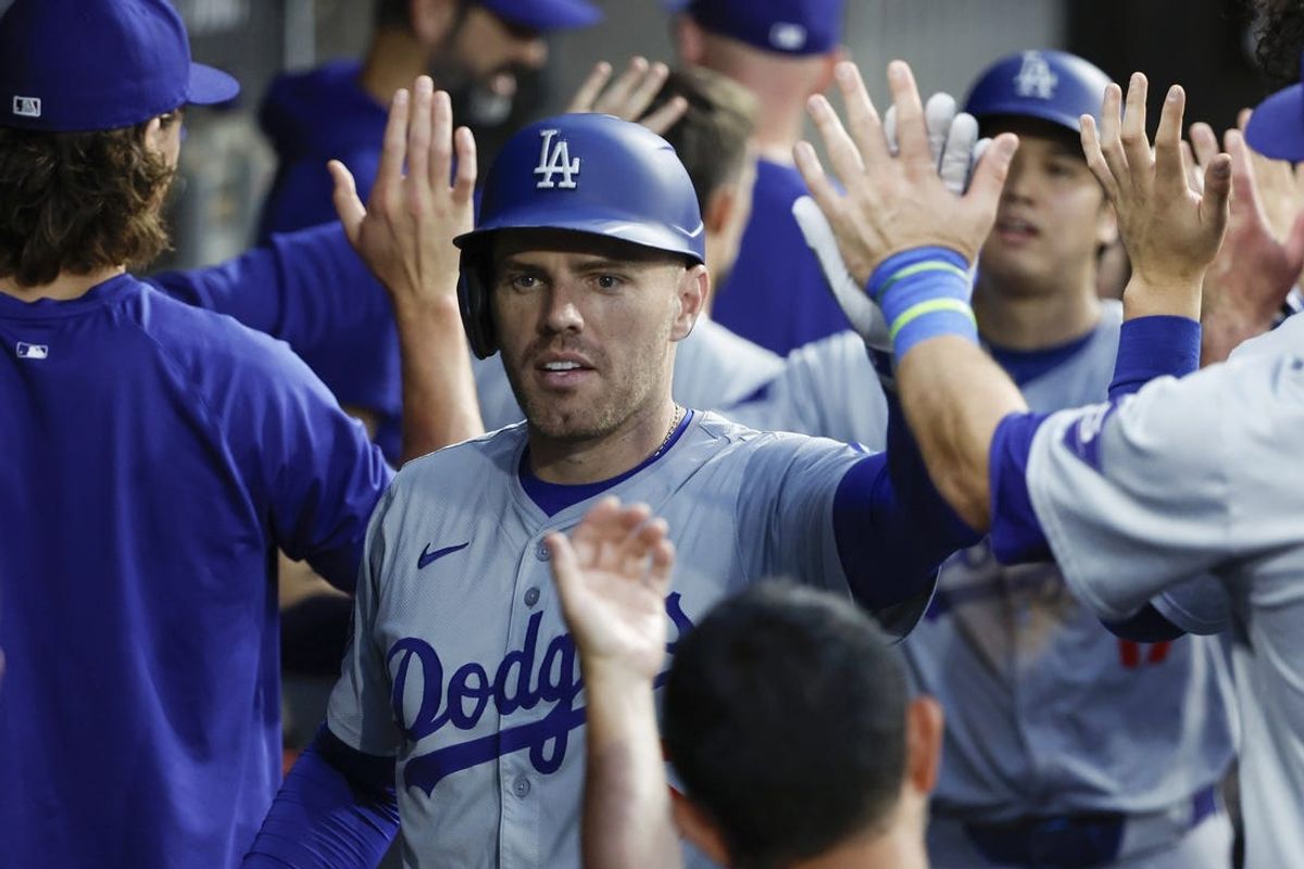 Jun 25, 2024; Chicago, Illinois, USA; Los Angeles Dodgers first baseman Freddie Freeman (5) celebrates with teammates in the dugout after hitting a two-run home run against the Chicago White Sox during the third inning at Guaranteed Rate Field. Mandatory Credit: Kamil Krzaczynski-USA TODAY Sports