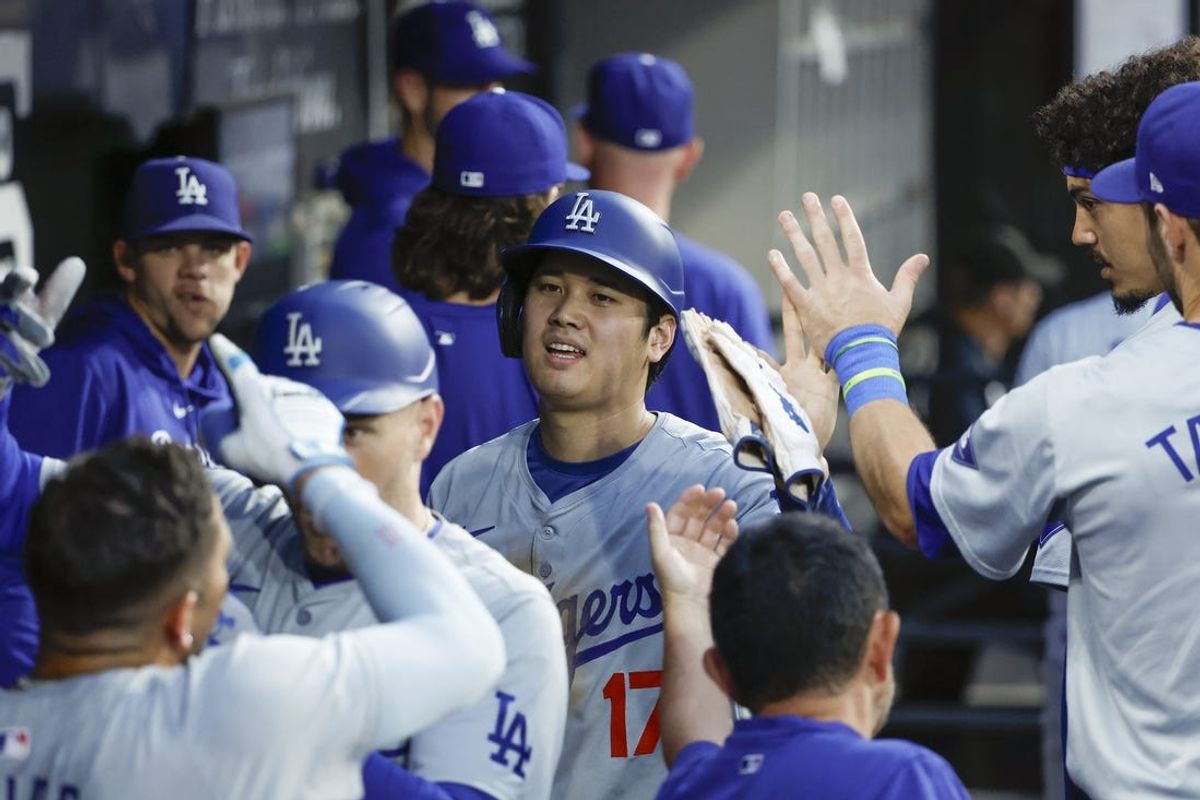 Jun 25, 2024; Chicago, Illinois, USA; Los Angeles Dodgers designated hitter Shohei Ohtani (17) celebrates with teammates in the dugout after scoring against the Chicago White Sox during the third inning at Guaranteed Rate Field. Mandatory Credit: Kamil Krzaczynski-USA TODAY Sports