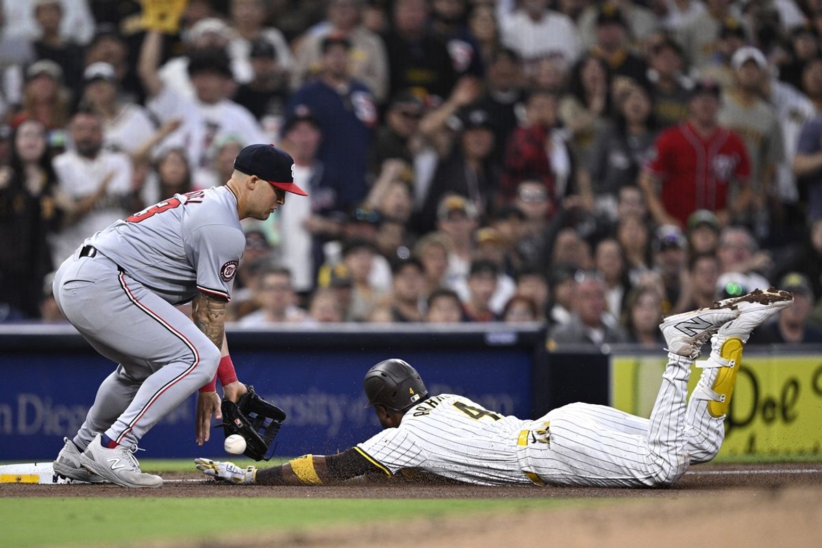 Jun 25, 2024; San Diego, California, USA; San Diego Padres first baseman Luis Arraez (4) slides into third base safely past Washington Nationals third baseman Nick Senzel (13) after hitting a triple during the fifth inning at Petco Park. Mandatory Credit: Orlando Ramirez-Imagn Images