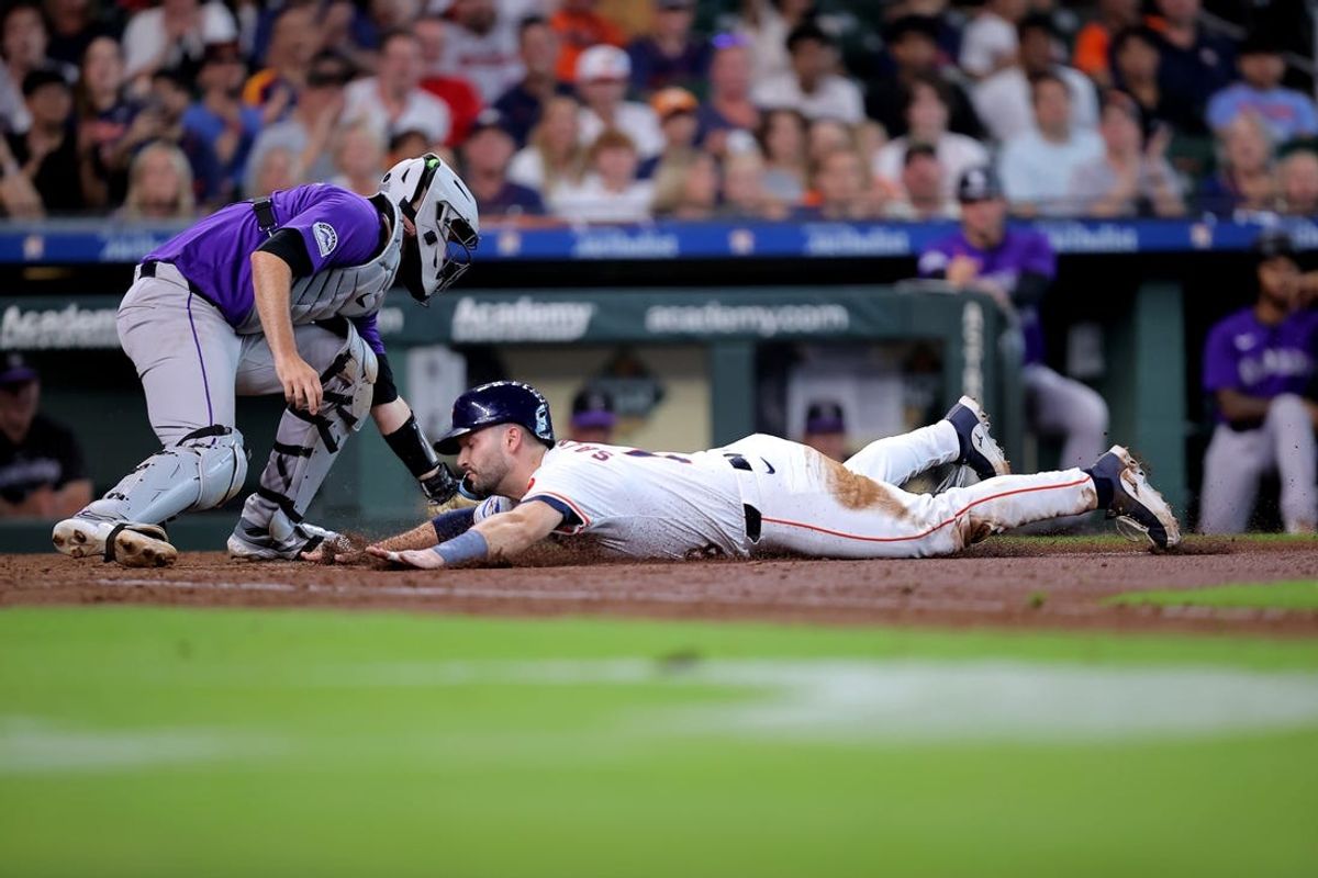 Jun 26, 2024; Houston, Texas, USA; Houston Astros catcher Cesar Salazar (18) slides into home plate to score a run against the Colorado Rockies during the fifth inning at Minute Maid Park. Mandatory Credit: Erik Williams-USA TODAY Sports