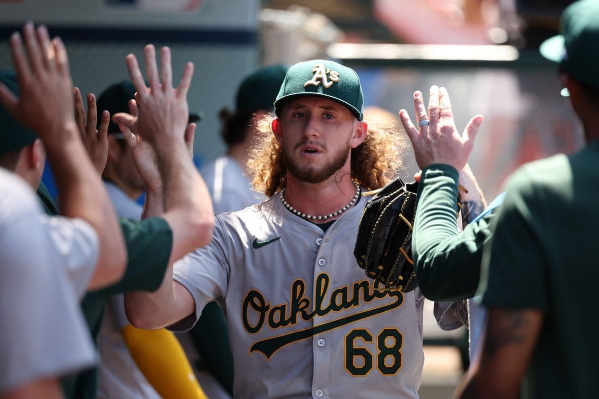 Jun 26, 2024; Anaheim, California, USA;  Oakland Athletics starting pitcher Joey Estes (68) is greeted in the dugout after being relieved from the game during the sixth inning against the Los Angeles Angels at Angel Stadium. Mandatory Credit: Kiyoshi Mio-USA TODAY Sports