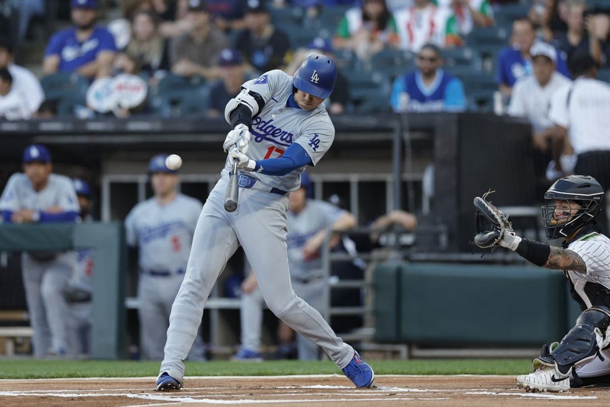 Jun 26, 2024; Chicago, Illinois, USA; Los Angeles Dodgers designated hitter Shohei Ohtani (17) hits a solo home run against the Chicago White Sox  during the first inning at Guaranteed Rate Field. Mandatory Credit: Kamil Krzaczynski-USA TODAY Sports