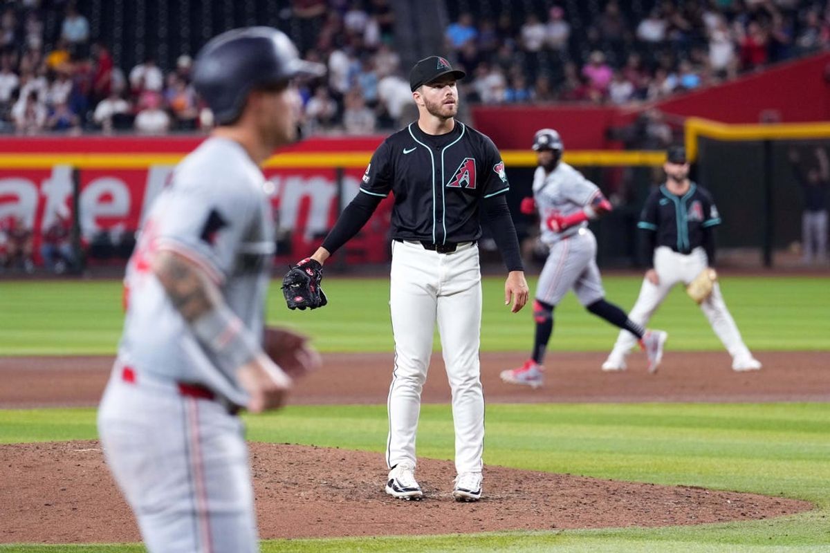 Jun 26, 2024; Phoenix, Arizona, USA; Arizona Diamondbacks pitcher Brandon Hughes (56) reacts after giving up a two run home run to Minnesota Twins shortstop Willi Castro (50) during the fifth inning at Chase Field. Mandatory Credit: Joe Camporeale-USA TODAY Sports
