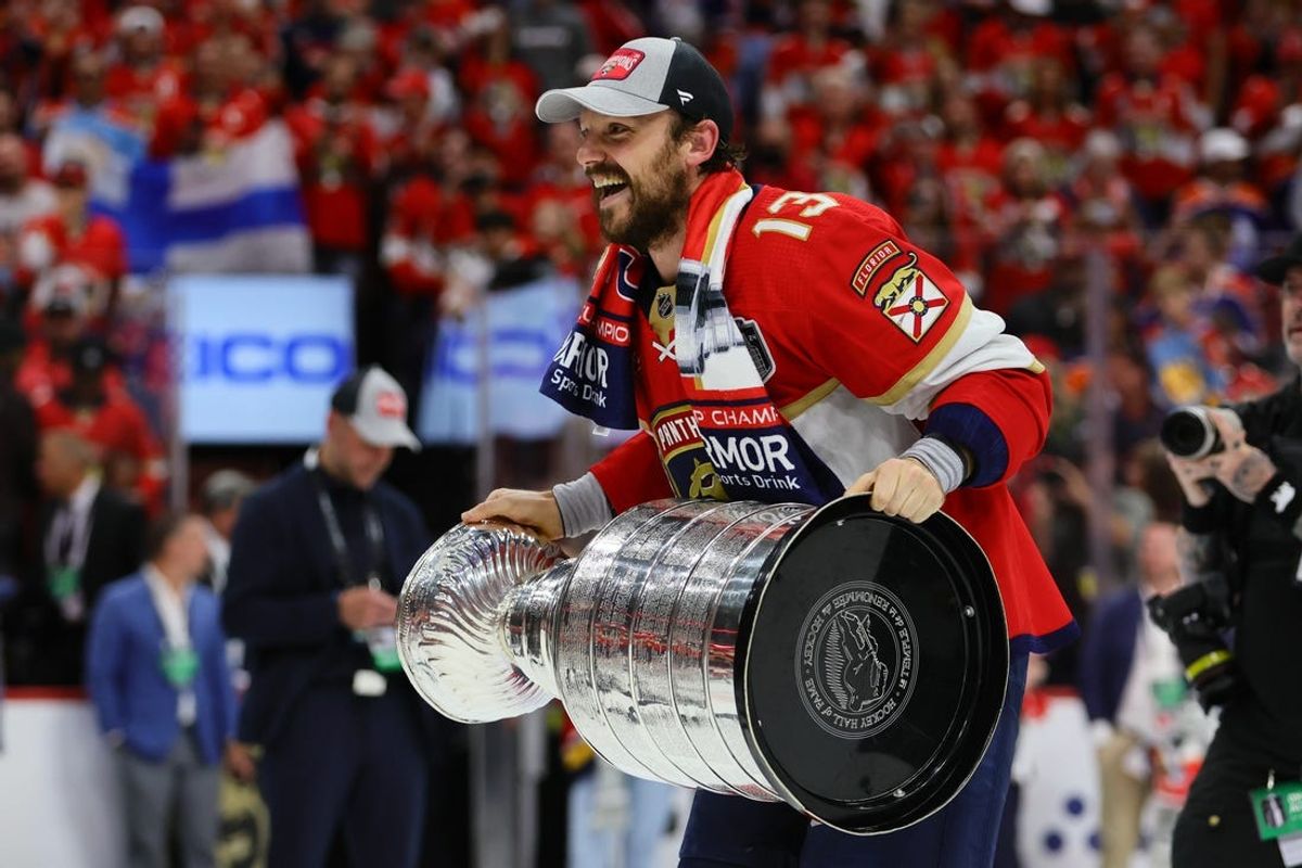 Jun 24, 2024; Sunrise, Florida, USA; Florida Panthers center Sam Reinhart (13) skates with the cup after winning game seven of the 2024 Stanley Cup Final against the Edmonton Oilers at Amerant Bank Arena. Mandatory Credit: Sam Navarro-USA TODAY Sports