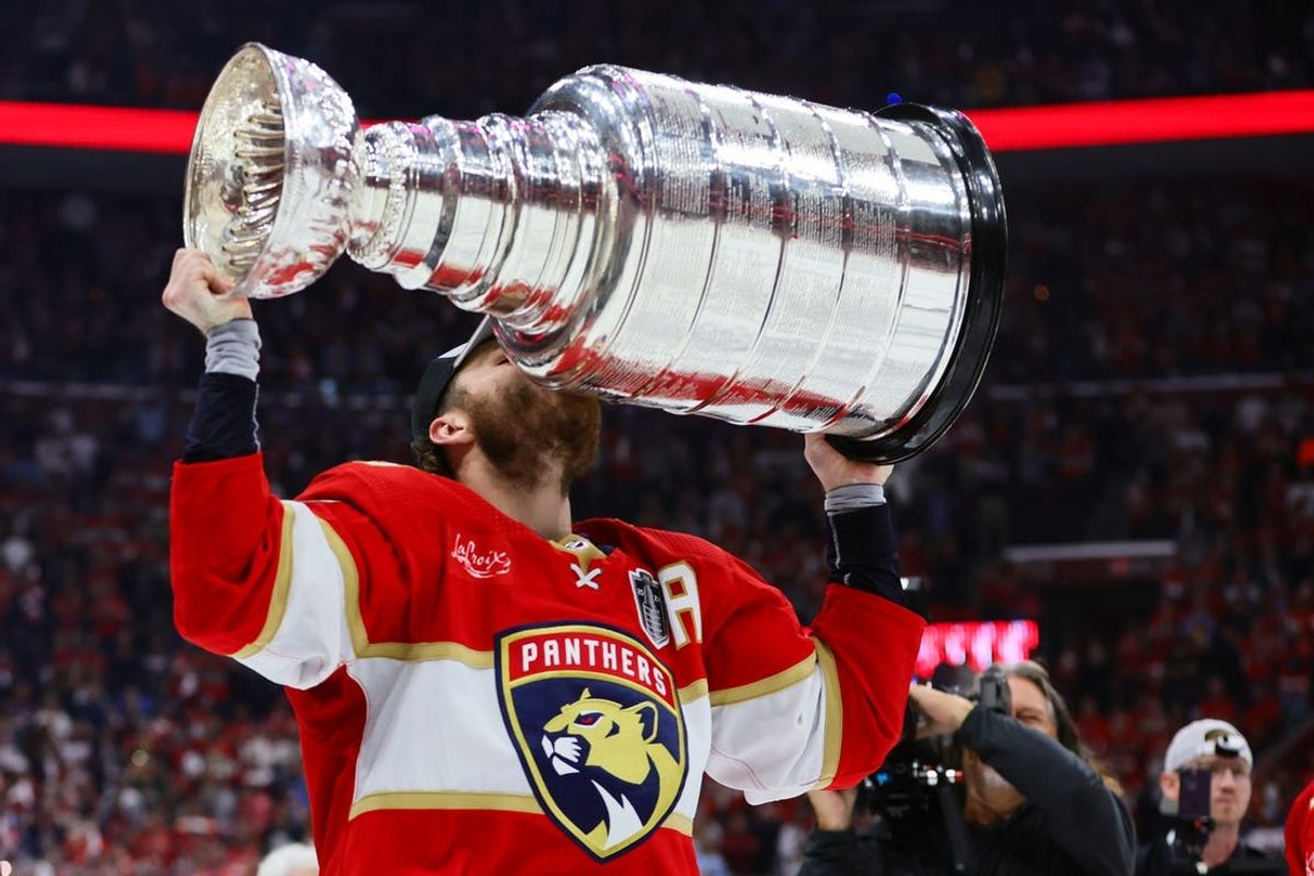 Jun 24, 2024; Sunrise, Florida, USA; Florida Panthers left wing Matthew Tkachuk (19) kisses the cup after winning game seven of the 2024 Stanley Cup Final against the Edmonton Oilers at Amerant Bank Arena. Mandatory Credit: Sam Navarro-USA TODAY Sports