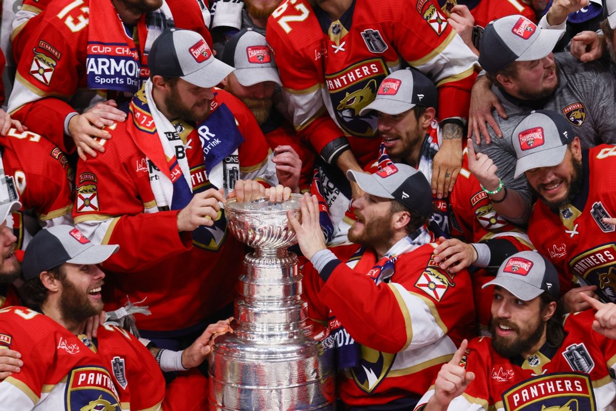Jun 24, 2024; Sunrise, Florida, USA; Florida Panthers left wing Matthew Tkachuk (19), center Aleksander Barkov (16) and teammates celebrate with the cup after winning game seven of the 2024 Stanley Cup Final against the Edmonton Oilers at Amerant Bank Arena. Mandatory Credit: Sam Navarro-Imagn Images