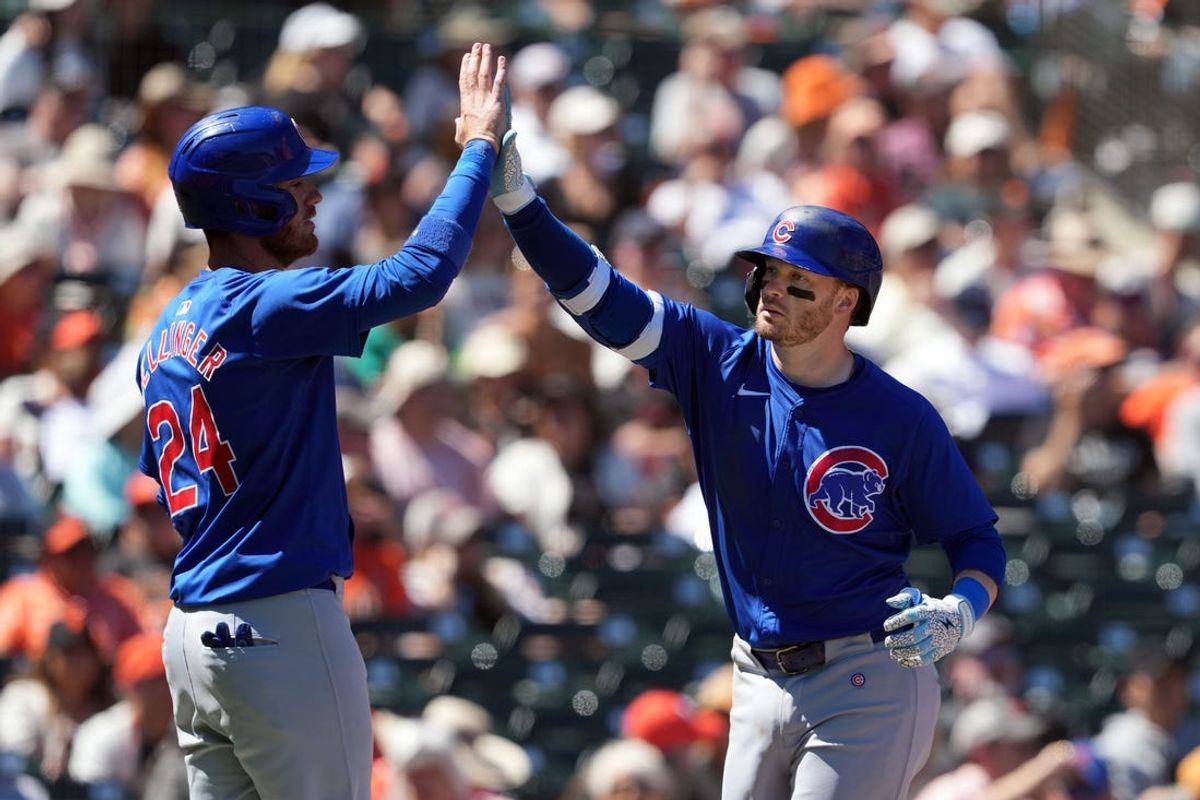 Jun 27, 2024; San Francisco, California, USA; Chicago Cubs designated hitter Ian Happ (right) celebrates with right fielder Cody Ballinger (24) after hitting a home run against the San Francisco Giants during the tenth inning at Oracle Park. Mandatory Credit: Darren Yamashita-USA TODAY Sports