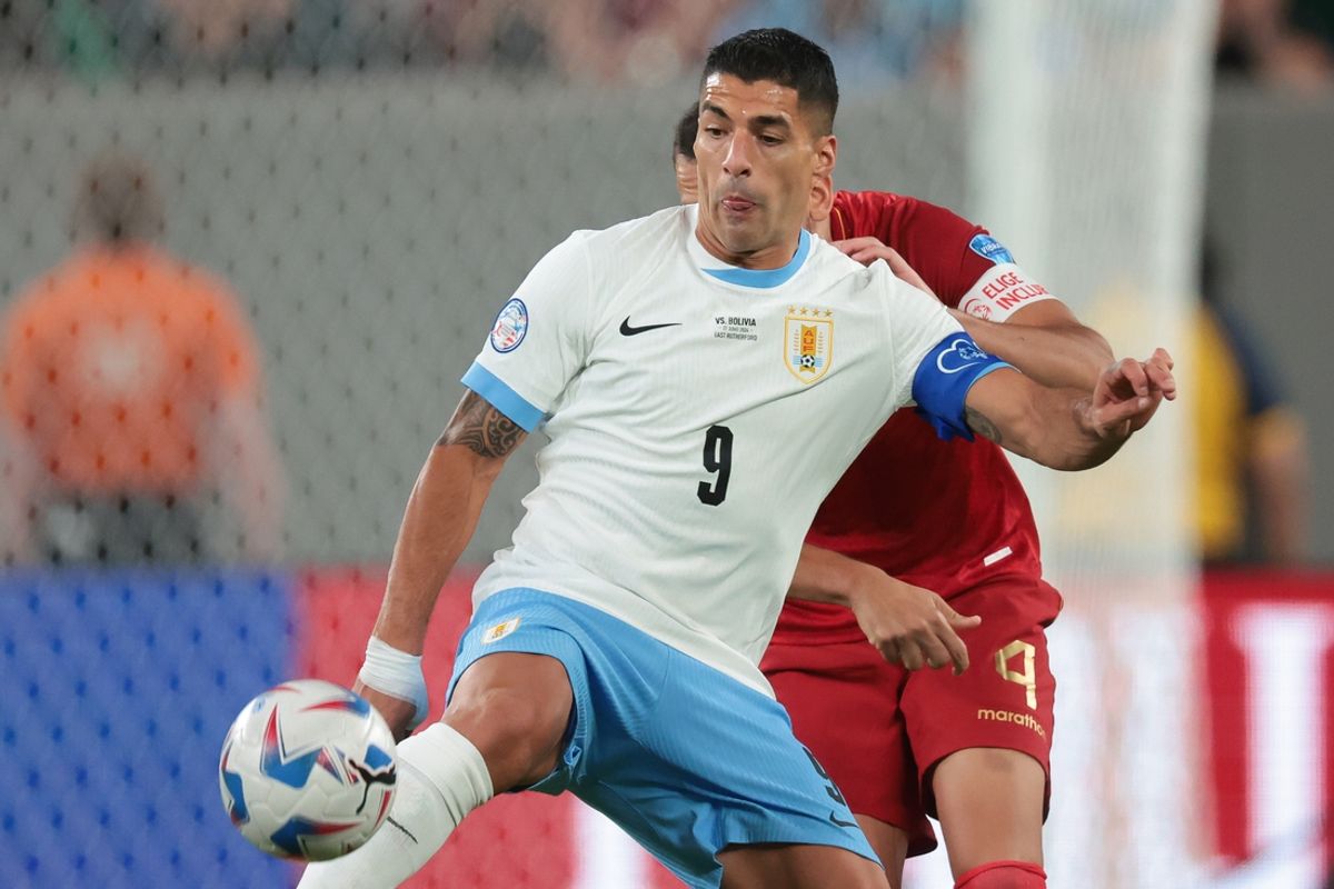 Jun 27, 2024; East Rutherford, NJ, USA; Uruguay forward Luis Suarez (9) plays the ball in front of Bolivia defender Luis Haquin (4) during the second half of the Copa America match at MetLife Stadium. Mandatory Credit: Vincent Carchietta-USA TODAY Sports