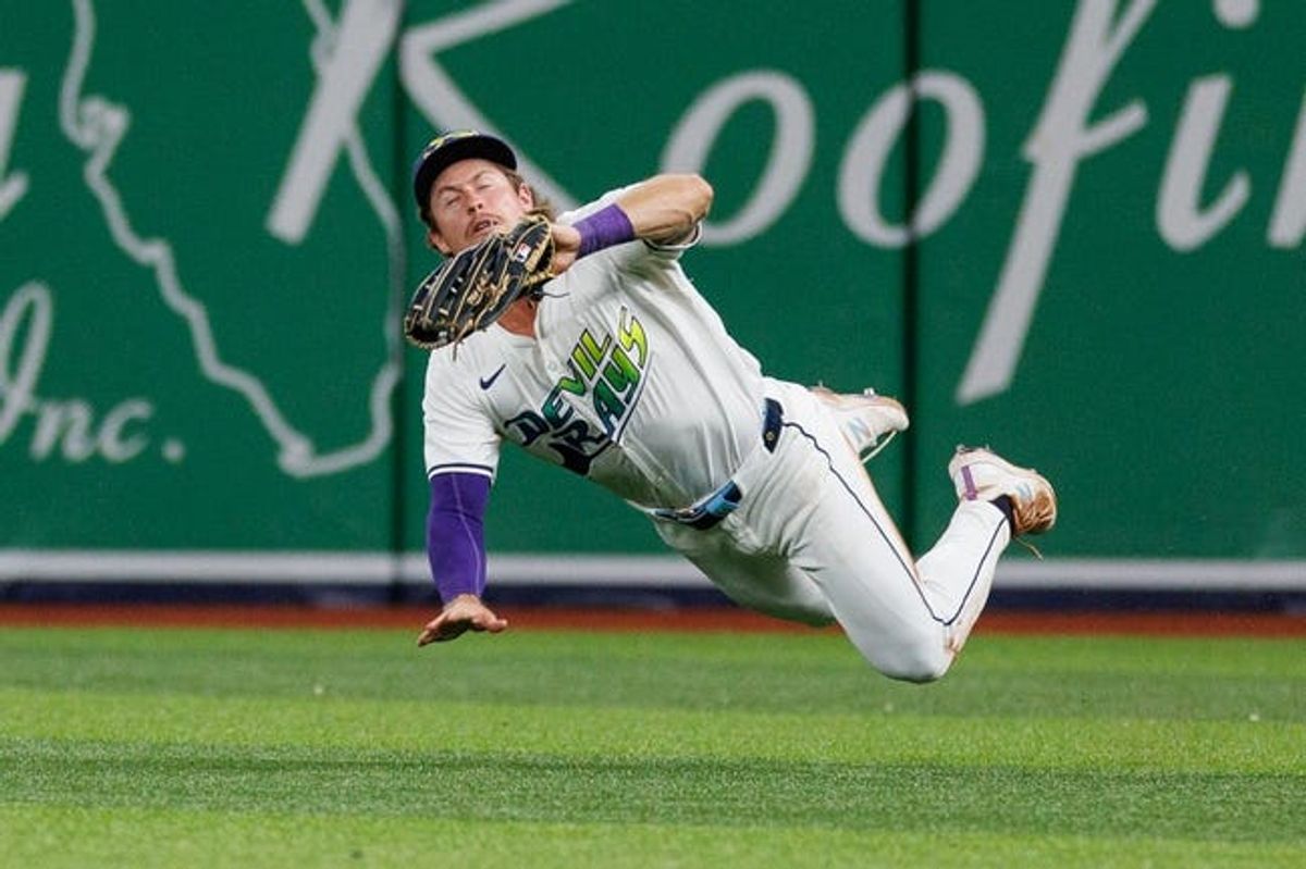 Jun 28, 2024; St. Petersburg, Florida, USA;  Tampa Bay Rays outfielder Jonny DeLuca (21) makes a diving catch against the Washington Nationals in the ninth inning at Tropicana Field. Mandatory Credit: Nathan Ray Seebeck-USA TODAY Sports