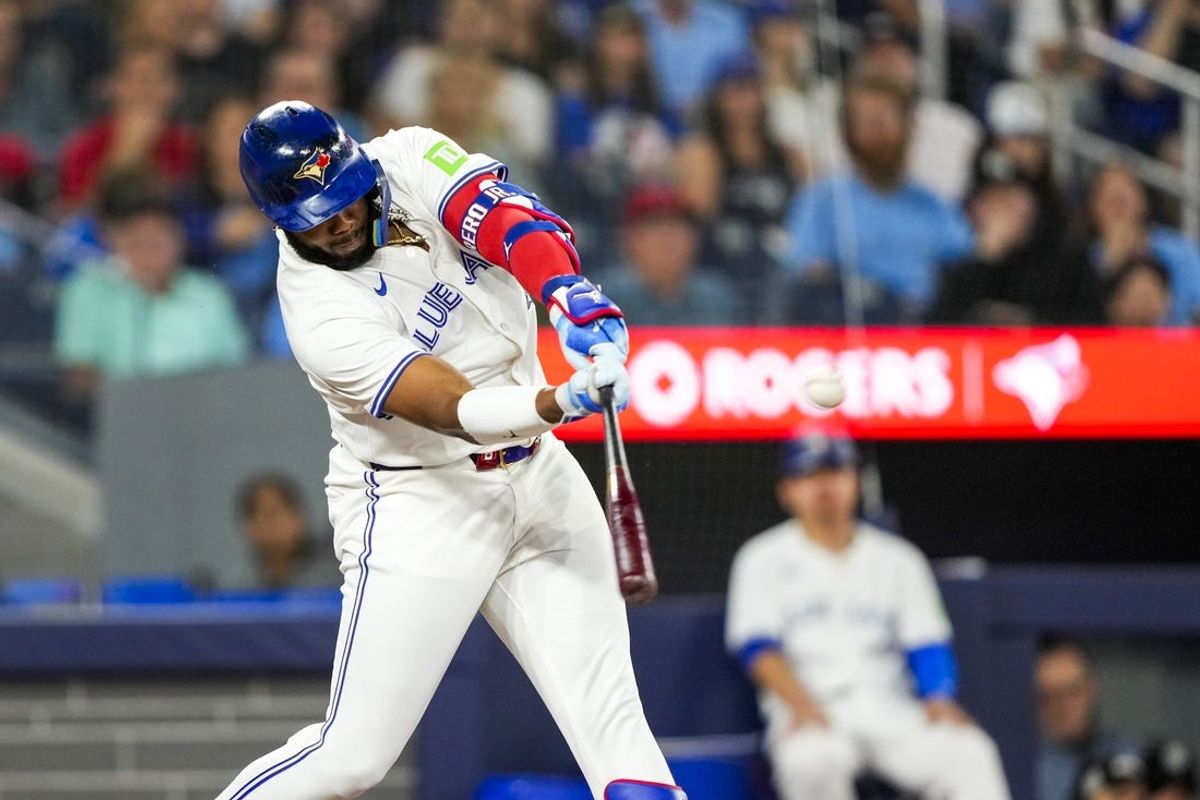 Jun 29, 2024; Toronto, Ontario, CAN; Toronto Blue Jays first base Vladimir Guerrero Jr. (27) hits a home run against the New York Yankees during the first inning at Rogers Centre. Mandatory Credit: Kevin Sousa-USA TODAY Sports