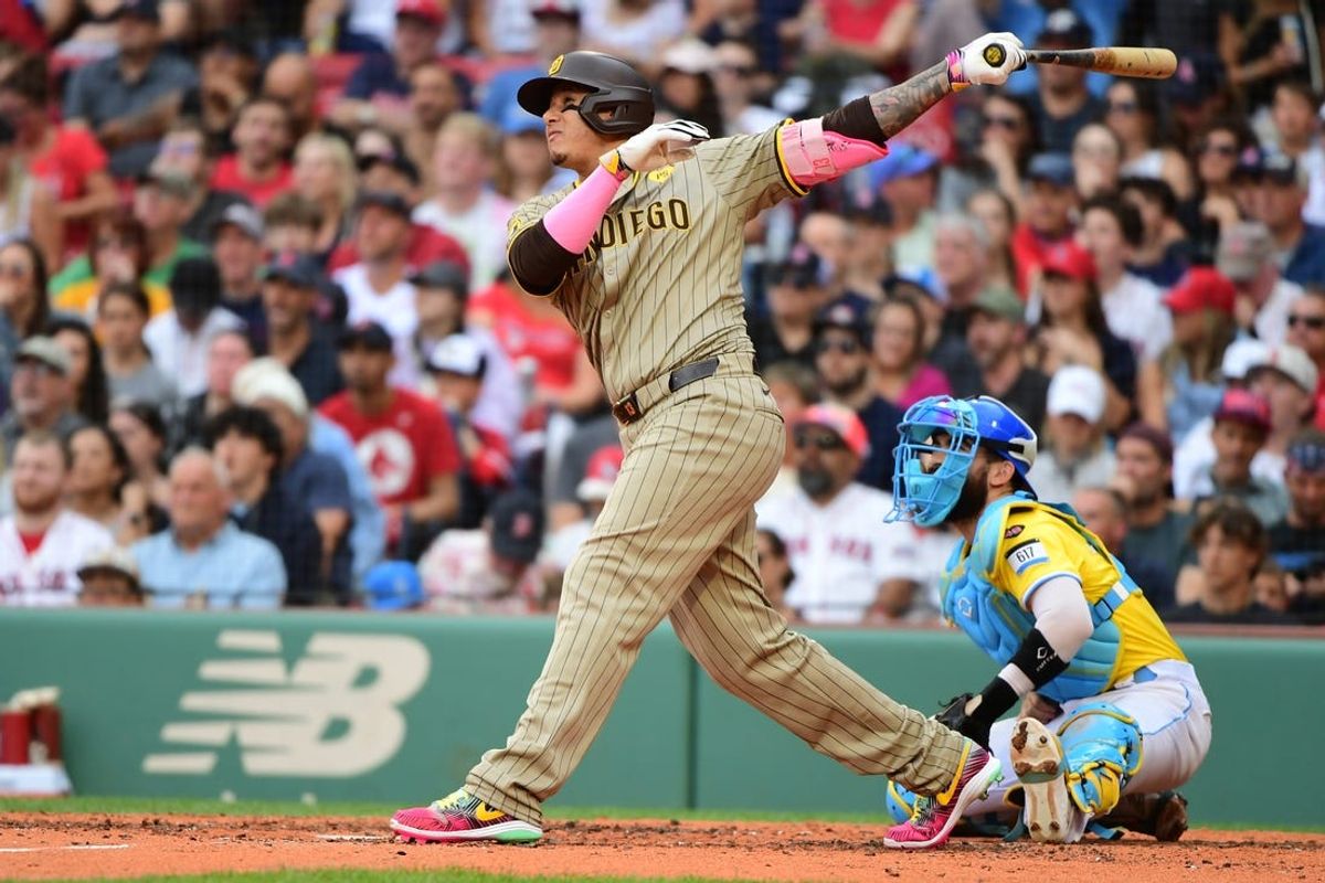Jun 29, 2024; Boston, Massachusetts, USA;  San Diego Padres designated hitter Manny Machado (13) hits a three run home run during the fifth inning against the Boston Red Sox at Fenway Park. Mandatory Credit: Bob DeChiara-USA TODAY Sports