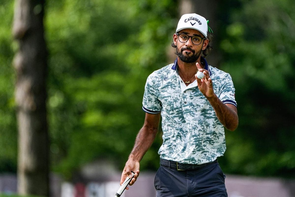 Akshay Bhatia waves at fans after putting the 9th during Round 3 of Rocket Mortgage Classic at Detroit Golf Club in Detroit on Saturday, June 29, 2024.