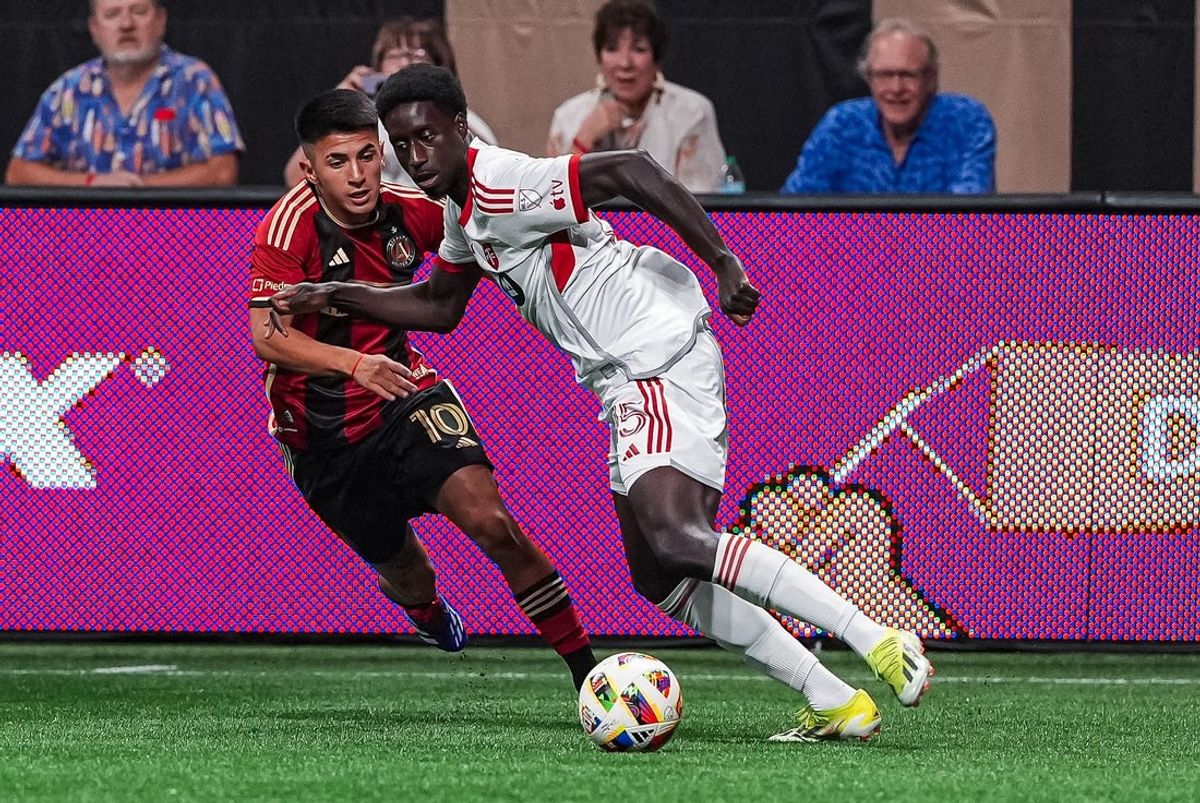 Jun 29, 2024; Atlanta, Georgia, USA; Toronto FC defender Nicksoen Gomis (15) plays the ball away from Atlanta United midfielder Thiago Almada (10) during the first half at Mercedes-Benz Stadium. Mandatory Credit: Dale Zanine-USA TODAY Sports