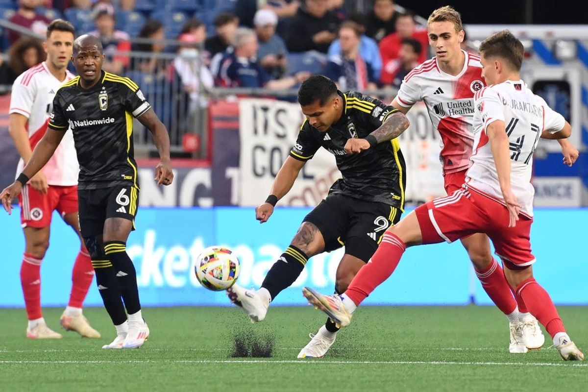 Jun 29, 2024; Foxborough, Massachusetts, USA; Columbus Crew forward Cucho Hernandez (9) kicks the ball against New England Revolution forward Esmir Bajraktarevic (47) during the first half at Gillette Stadium. Mandatory Credit: Eric Canha-USA TODAY Sports