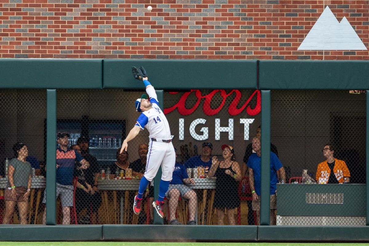 Jun 29, 2024; Cumberland, Georgia, USA; Atlanta Braves outfielder Adam Duvall (14) jumps the catch fly ball against the Pittsburgh Pirates during the eighth inning at Truist Park. Mandatory Credit: Jordan Godfree-USA TODAY Sports