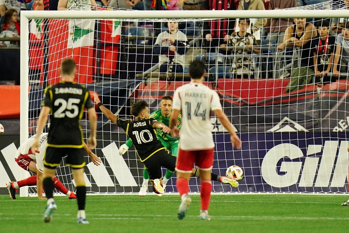 Jun 29, 2024; Foxborough, Massachusetts, USA; Columbus Crew forward Diego Rossi (10) scores a goal against New England Revolution goalkeeper Aljaz Ivacic (31) during the first half at Gillette Stadium. Mandatory Credit: David Butler II-USA TODAY Sports