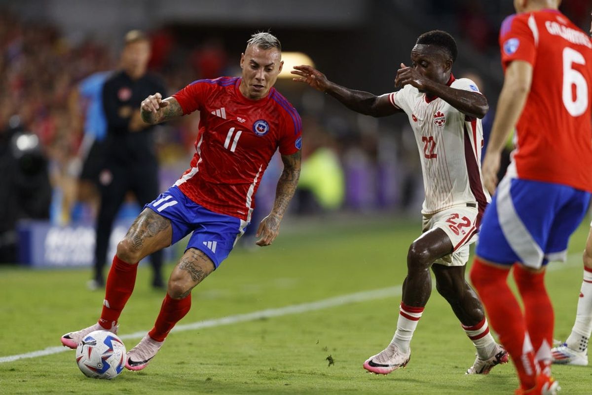 Jun 29, 2024; Orlando, FL, USA; Chile forward Eduardo Vargas (11) dribbles the ball against Canada defender Richie Laryea (22) during the first half at Inter&Co Stadium. Mandatory Credit: Morgan Tencza-USA TODAY Sports
