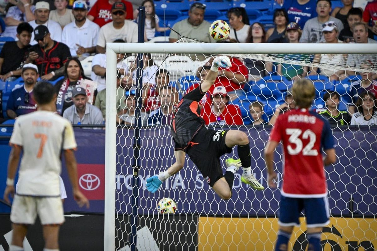 Jun 29, 2024; Frisco, Texas, USA; FC Dallas goalkeeper Maarten Paes (30) leaps for the ball after a FC Cincinnati shot on goal during the first half at Toyota Stadium. Mandatory Credit: Jerome Miron-USA TODAY Sports