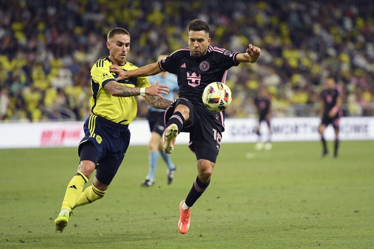 Jun 29, 2024; Nashville, Tennessee, USA; Inter Miami CF defender Jordi Alba (18) and Nashville SC forward Tyler Boyd (11) battle for the ball in the second half at Geodis Park. Mandatory Credit: Steve Roberts-USA TODAY Sports