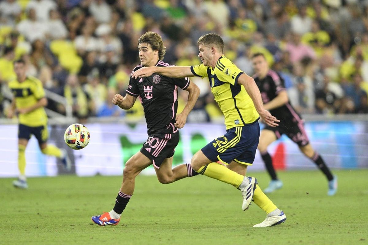 Jun 29, 2024; Nashville, Tennessee, USA; Inter Miami CF midfielder Benjamin Cremaschi (30) and Nashville SC defender Josh Bauer (22) battle for the ball in the second half at Geodis Park. Mandatory Credit: Steve Roberts-USA TODAY Sports