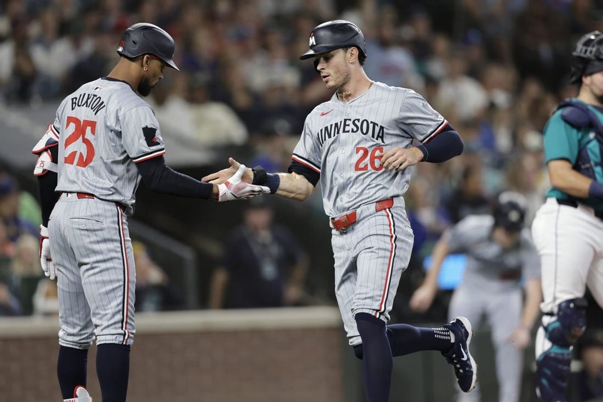 Jun 29, 2024; Seattle, Washington, USA; Minnesota Twins right fielder Max Kepler (26) scores and is greeted by Minnesota Twins outfielder Byron Buxton (25) during the second inning at T-Mobile Park. Mandatory Credit: John Froschauer-USA TODAY Sports