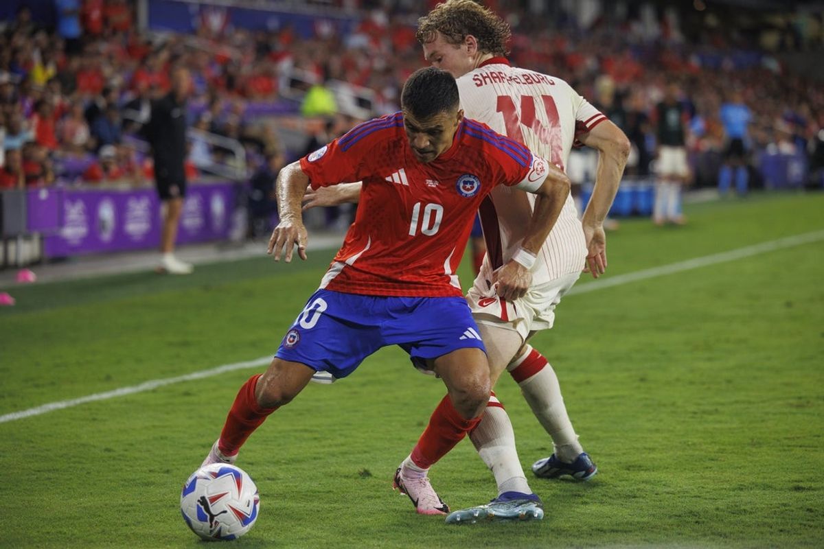 Jun 29, 2024; Orlando, FL, USA; Chile forward Alexis Sanchez (10) dribbles the ball around Canada forward Jacob Shaffelburg (14) during the second half at Inter&Co Stadium. Mandatory Credit: Morgan Tencza-Imagn Images