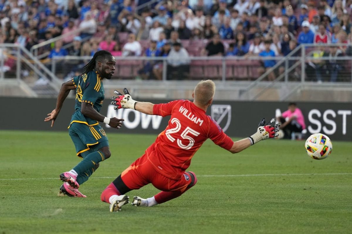 Jun 29, 2024; San Jose, California, USA; LA Galaxy forward Joseph Paintsil (28) scores a goal against San Jose Earthquakes goalkeeper William Yarbrough (25) in the first half at Stanford Stadium. Mandatory Credit: Darren Yamashita-USA TODAY Sports