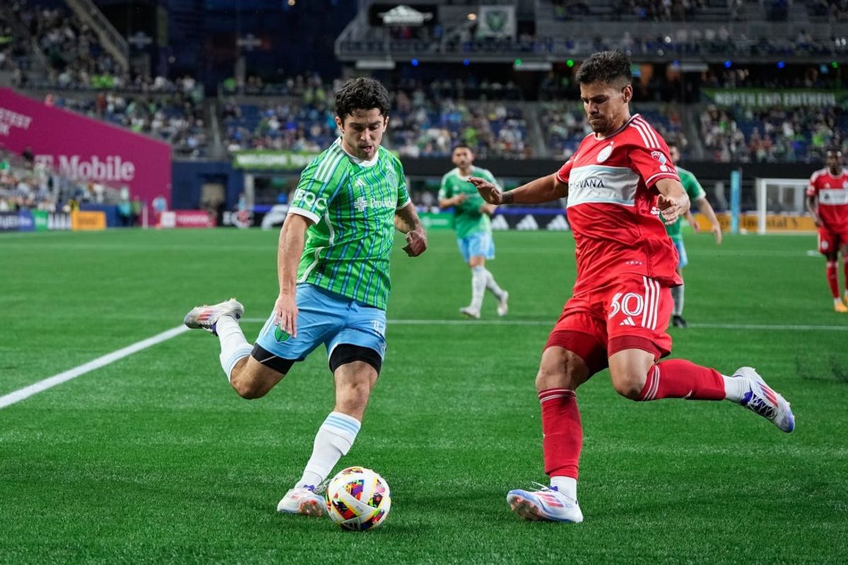 Jun 29, 2024; Seattle, Washington, USA; Seattle Sounders FC forward Paul Rothrock (14) attempts to pass as Chicago Fire FC midfielder Gaston Gimenez (30) defends during the second half at Lumen Field. Mandatory Credit: Stephen Brashear-USA TODAY Sports