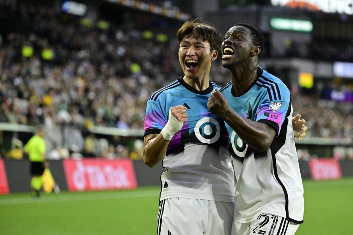 Jun 29, 2024; Portland, Oregon, USA; Minnesota United forward Jeong Sang-Bin (11) celebrates a goal with  forward Bongokuhle Hlongwane (21) in the first half against the Portland Timbers at Providence Park. Mandatory Credit: Troy Wayrynen-USA TODAY Sports
