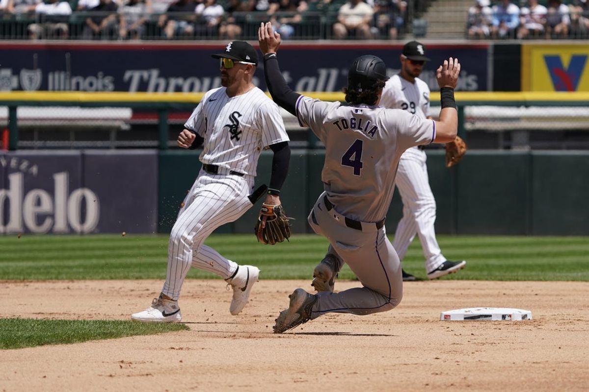 Jun 30, 2024; Chicago, Illinois, USA; Colorado Rockies first baseman Michael Toglia (4) steals second base as Chicago White Sox second baseman Danny Mendick (0) covers the base during the third inning at Guaranteed Rate Field. Mandatory Credit: David Banks-USA TODAY Sports