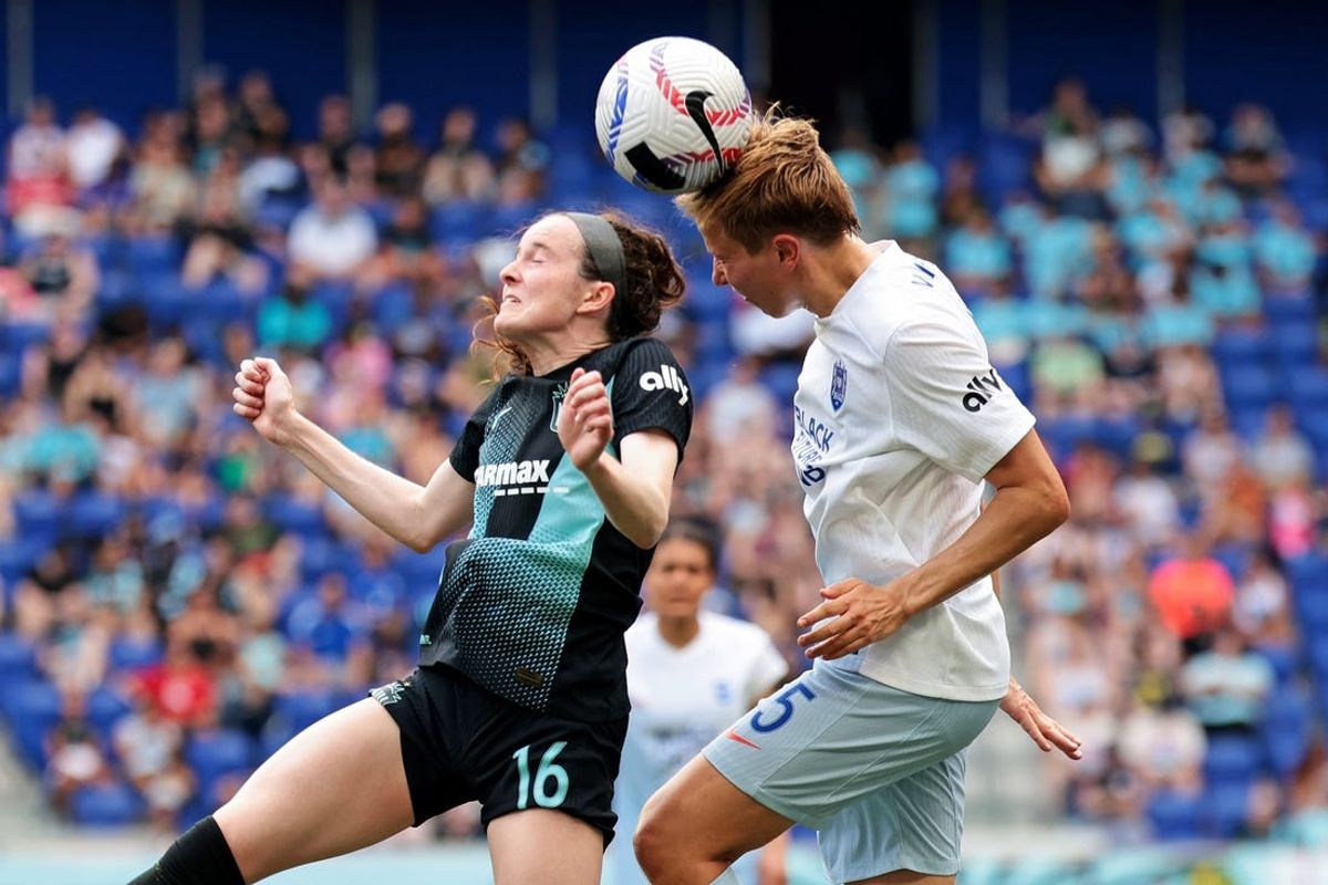 Jun 30, 2024; Harrison, New Jersey, USA; NJ/NY Gotham FC midfielder Rose Lavelle (16) and Seattle Reign FC midfielder Quinn (5) go for a header during the second half at Red Bull Arena. Mandatory Credit: Vincent Carchietta-USA TODAY Sports