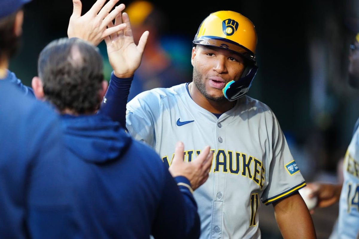 Jul 1, 2024; Denver, Colorado, USA; Milwaukee Brewers outfielder Jackson Chourio (11) celebrates scoring a run during the fourth inning against the Colorado Rockies at Coors Field. Mandatory Credit: Ron Chenoy-USA TODAY Sports