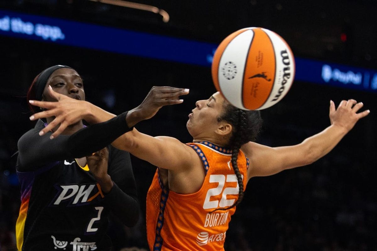 Phoenix Mercury guard Kahleah Copper (2) passes around Connecticut Sun guard Veronica Burton (22) on July 1, 2024 at Footprint Center in Phoenix.
