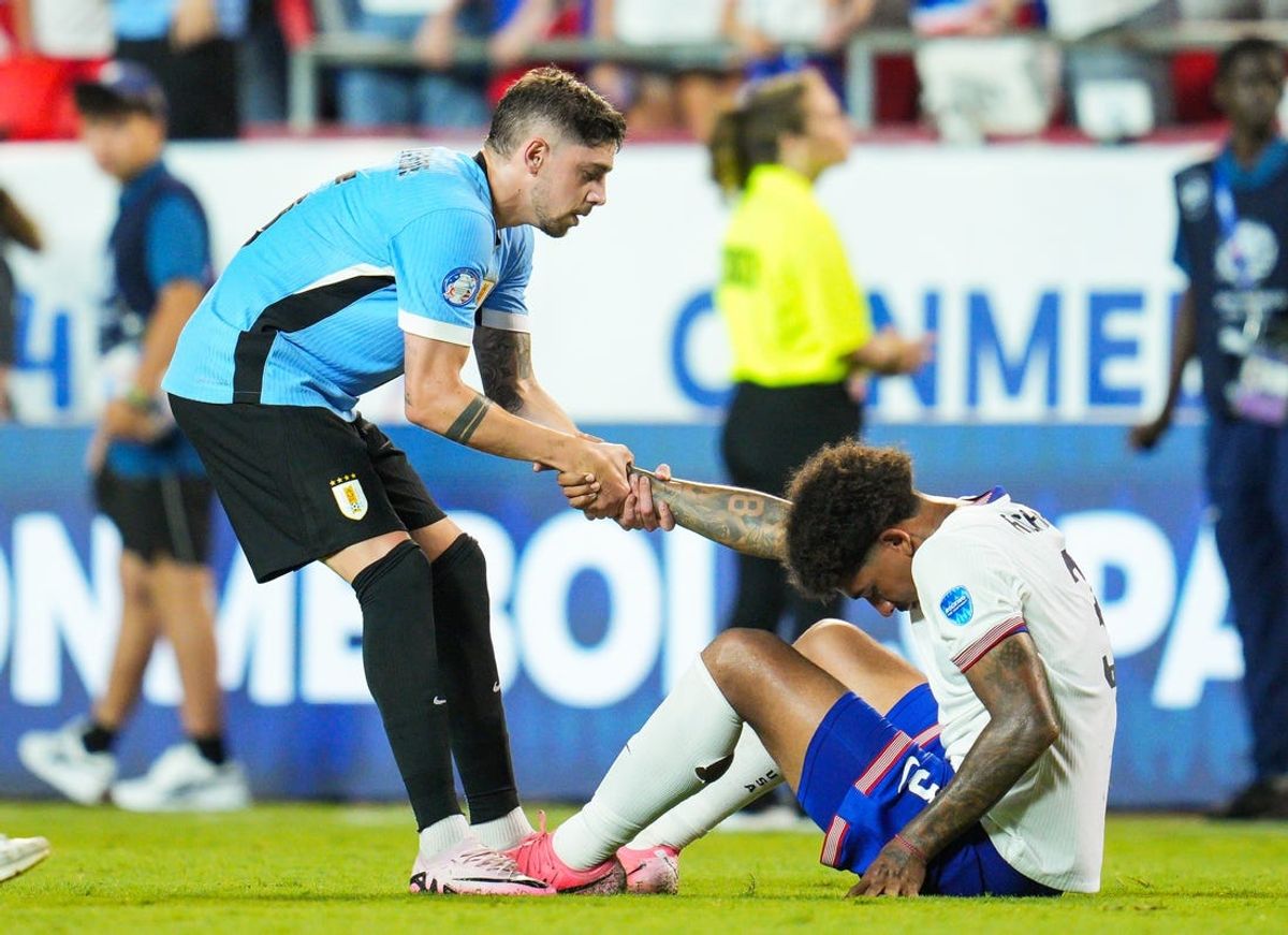 Jul 1, 2024; Kansas City, Missouri, USA; Uruguay midfielder Federico Valverde (15) helps United States defender Chris Richards (3) to his feet after a Copa America match at Arrowhead Stadium. Mandatory Credit: Jay Biggerstaff-USA TODAY Sports
