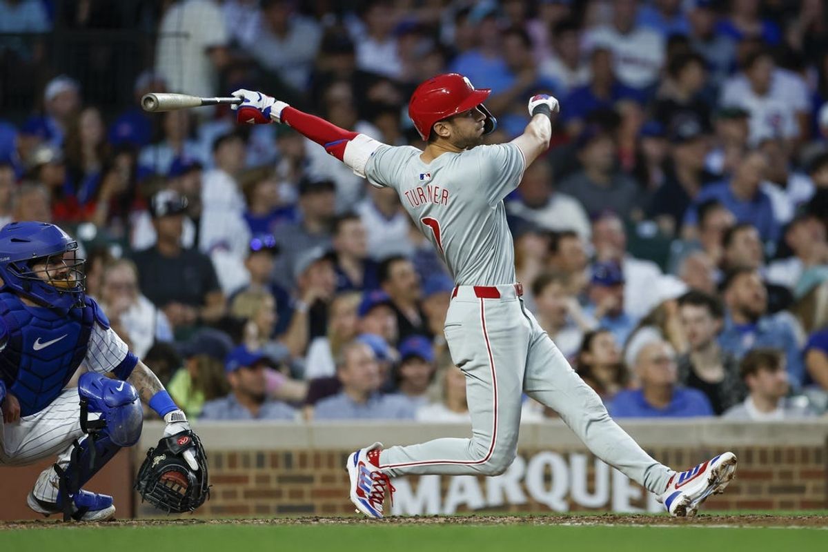 Jul 2, 2024; Chicago, Illinois, USA; Philadelphia Phillies shortstop Trea Turner (7) hits a two-run home run against the Chicago Cubs during the fifth inning at Wrigley Field. Mandatory Credit: Kamil Krzaczynski-USA TODAY Sports