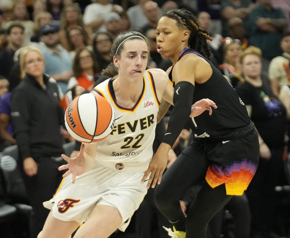 Jun 30, 2024; Phoenix, Ariz., U.S.; Indiana Fever guard Caitlin Clark (22) is fouled by Phoenix Mercury guard Sug Sutton (1) during the fourth quarter at Footprint Center.