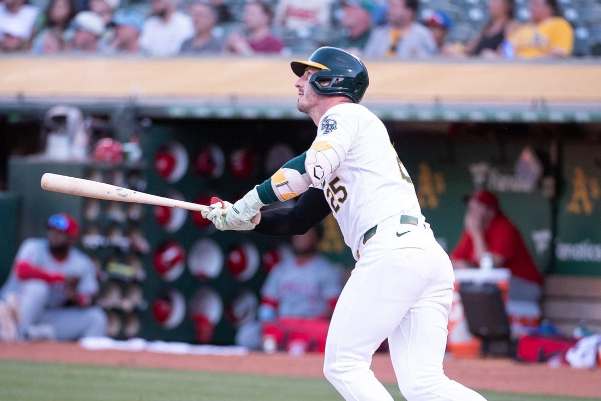 Jul 2, 2024; Oakland, California, USA; Oakland Athletics outfielder Brent Rooker (25) hits a home run against the Los Angeles Angels during the fourth inning at Oakland-Alameda County Coliseum. Mandatory Credit: Ed Szczepanski-USA TODAY Sports