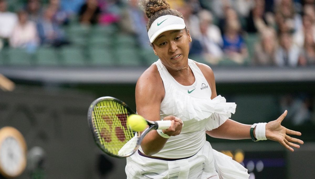 Jul 3, 2024; London, United Kingdom; Naomi Osaka of Japan returns a shot during her match against Emma Navarro of the United States (not shown) on day three of The Championships at All England Lawn Tennis and Croquet Club. Mandatory Credit: Susan Mullane-Imagn Images