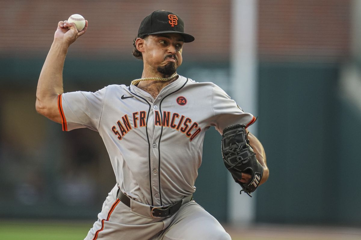 Jul 3, 2024; Cumberland, Georgia, USA; San Francisco Giants starting pitcher Jordan Hicks (12) pitches against the Atlanta Braves during the first inning at Truist Park. Mandatory Credit: Dale Zanine-USA TODAY Sports