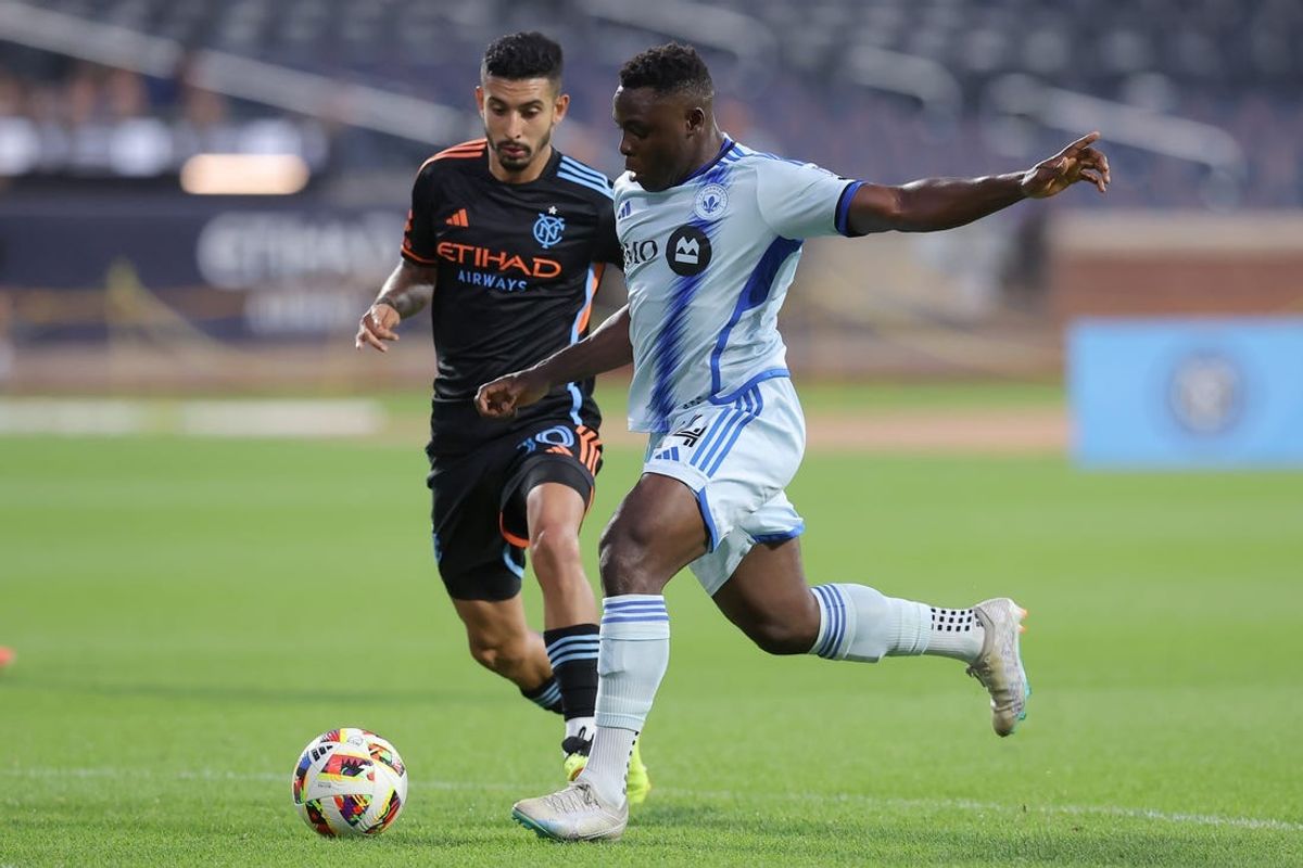 Jul 3, 2024; Queens, New York, USA; CF Montreal forward Sunusi Ibrahim (14) takes a shot against New York City FC midfielder Santiago Rodriguez (10) during the first half at Citi Field. Mandatory Credit: Brad Penner-USA TODAY Sports
