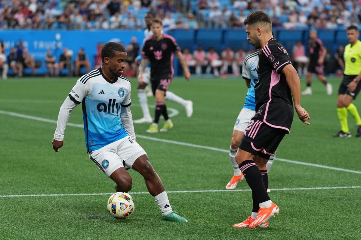 Jul 3, 2024; Charlotte, North Carolina, USA; Charlotte FC defender Nathan Byrne (14) controls the ball against Inter Miami CF defender Jordi Alba (18) in the first half at Bank of America Stadium. Mandatory Credit: Jim Dedmon-USA TODAY Sports
