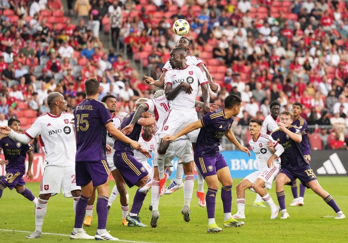 Jul 3, 2024; Toronto, Ontario, CAN; Toronto FC defender Aime Mabika (6) jumps for a ball  against Orlando City during the first half at BMO Field. Mandatory Credit: Nick Turchiaro-USA TODAY Sports
