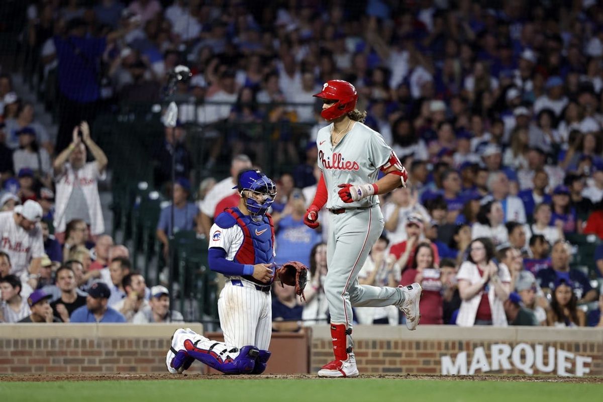 Jul 3, 2024; Chicago, Illinois, USA; Philadelphia Phillies third baseman Alec Bohm (28) crosses home plate after hitting a two-run home run against the Chicago Cubs during the sixth inning at Wrigley Field. Mandatory Credit: Kamil Krzaczynski-USA TODAY Sports