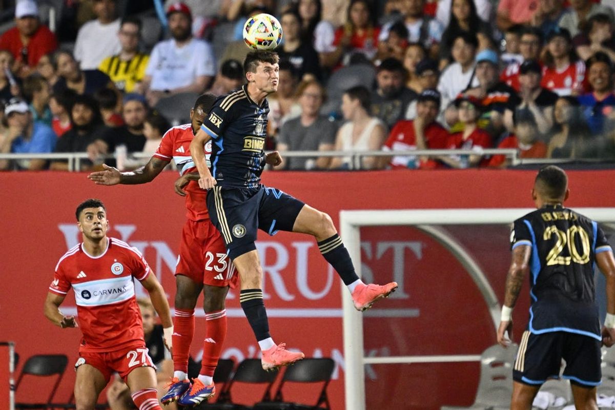 Jul 3, 2024; Chicago, Illinois, USA;  Philadelphia Union forward Chris Donovan (25) heads the ball in front of Chicago Fire FC midfielder Kellyn Acosta (23) in the second half at Soldier Field. Mandatory Credit: Jamie Sabau-USA TODAY Sports
