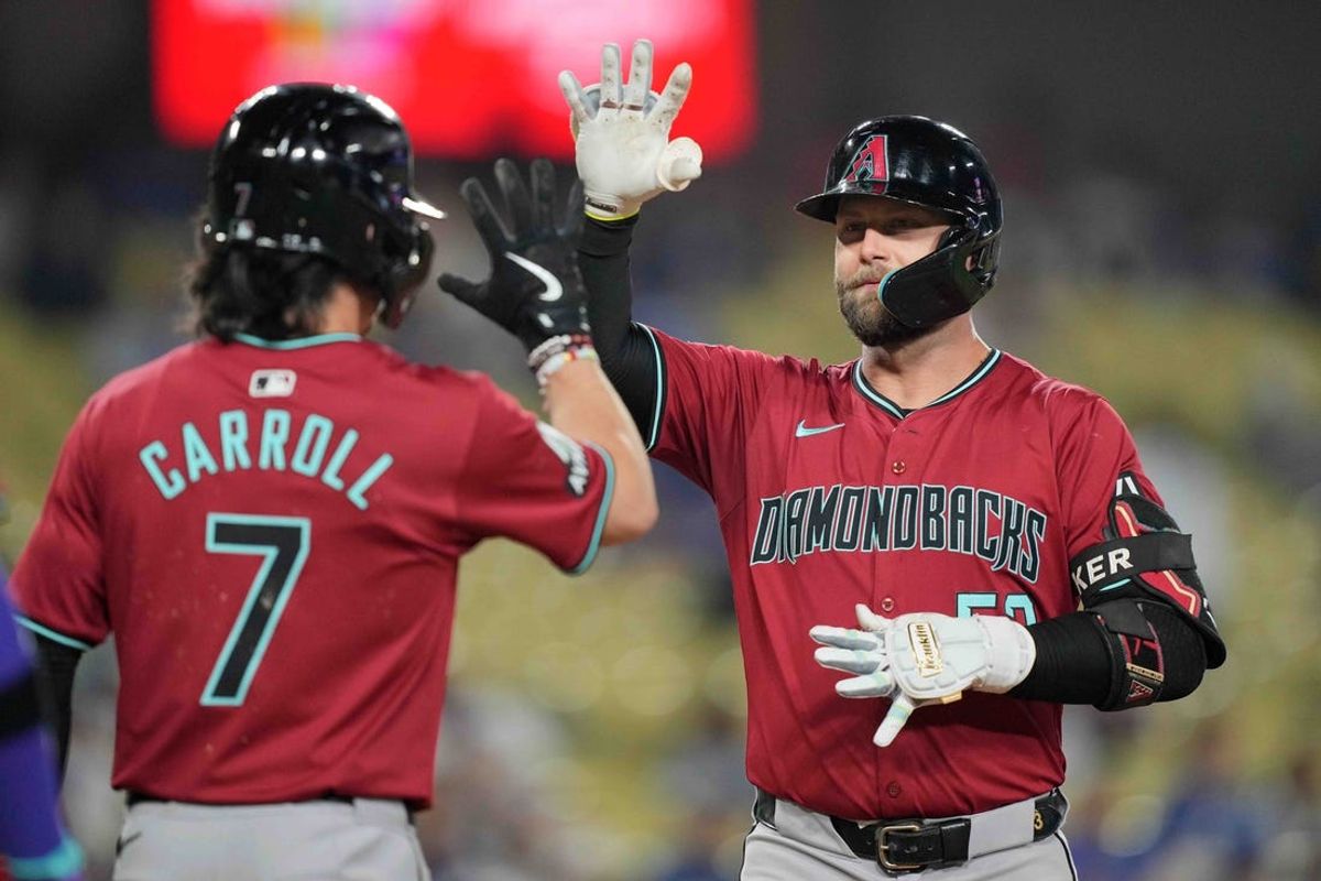 Jul 3, 2024; Los Angeles, California, USA; Arizona Diamondbacks first baseman Christian Walker (53) celebrates with center fielder Corbin Carroll (7) after hitting a three-run home run in the ninth inning against the Los Angeles Dodgers at Dodger Stadium. Mandatory Credit: Kirby Lee-USA TODAY Sports
