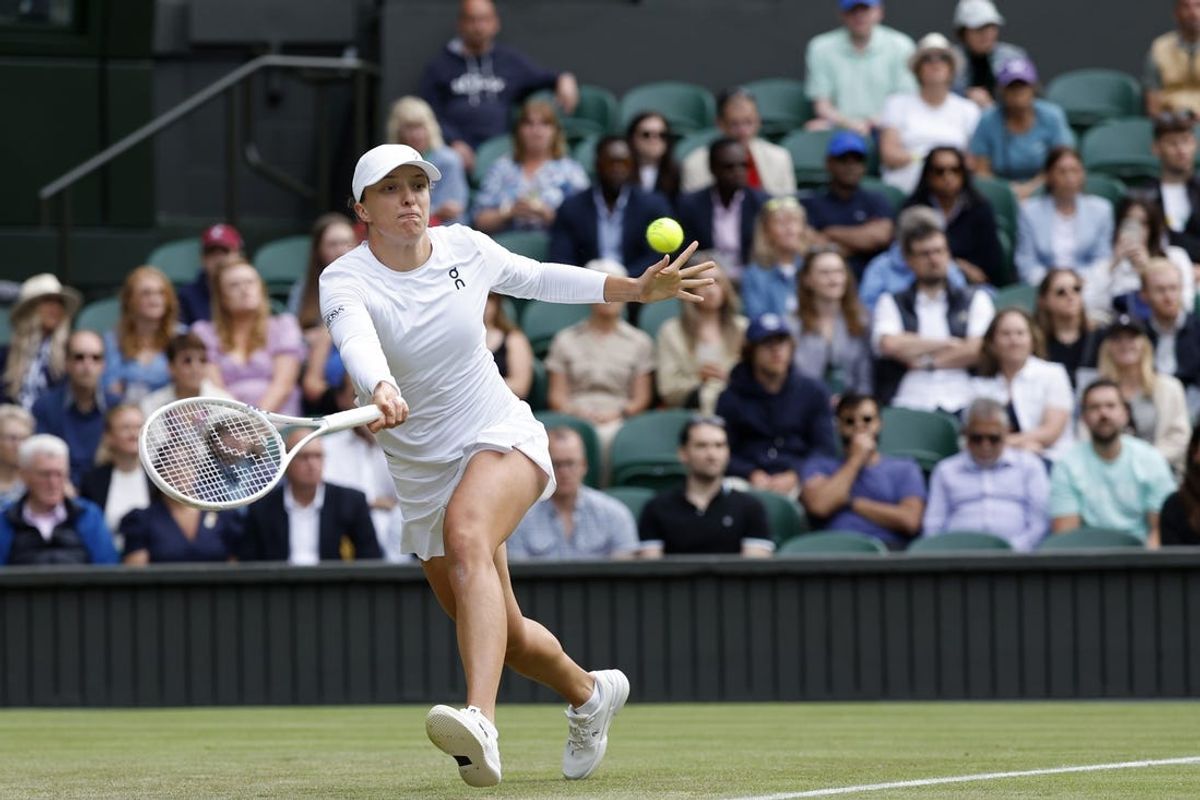 Jul 4, 2024; London, United Kingdom; Iga Swiatek (POL) hits a forehand against Petra Martic (CRO)(not pictured) in a ladies' singles match on day four of The Championships Wimbledon 2024 at All England Lawn Tennis and Croquet Club. Mandatory Credit: Geoff Burke-USA TODAY Sports