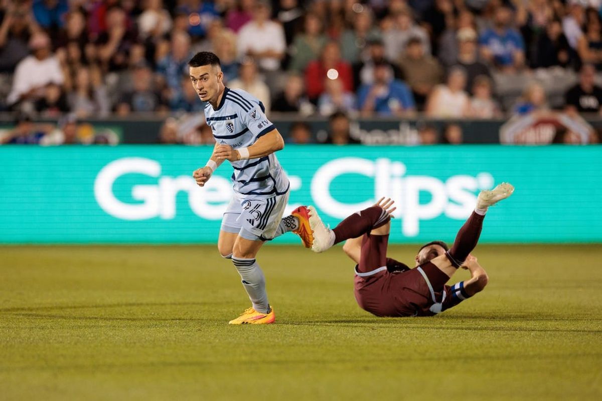 Jul 4, 2024; Commerce City, Colorado, USA; Sporting Kansas City midfielder Erik Thommy (26) collides with Colorado Rapids defender Keegan Rosenberry (2) during the second half at Dick's Sporting Goods Park. Mandatory Credit: Andrew Wevers-USA TODAY Sports
