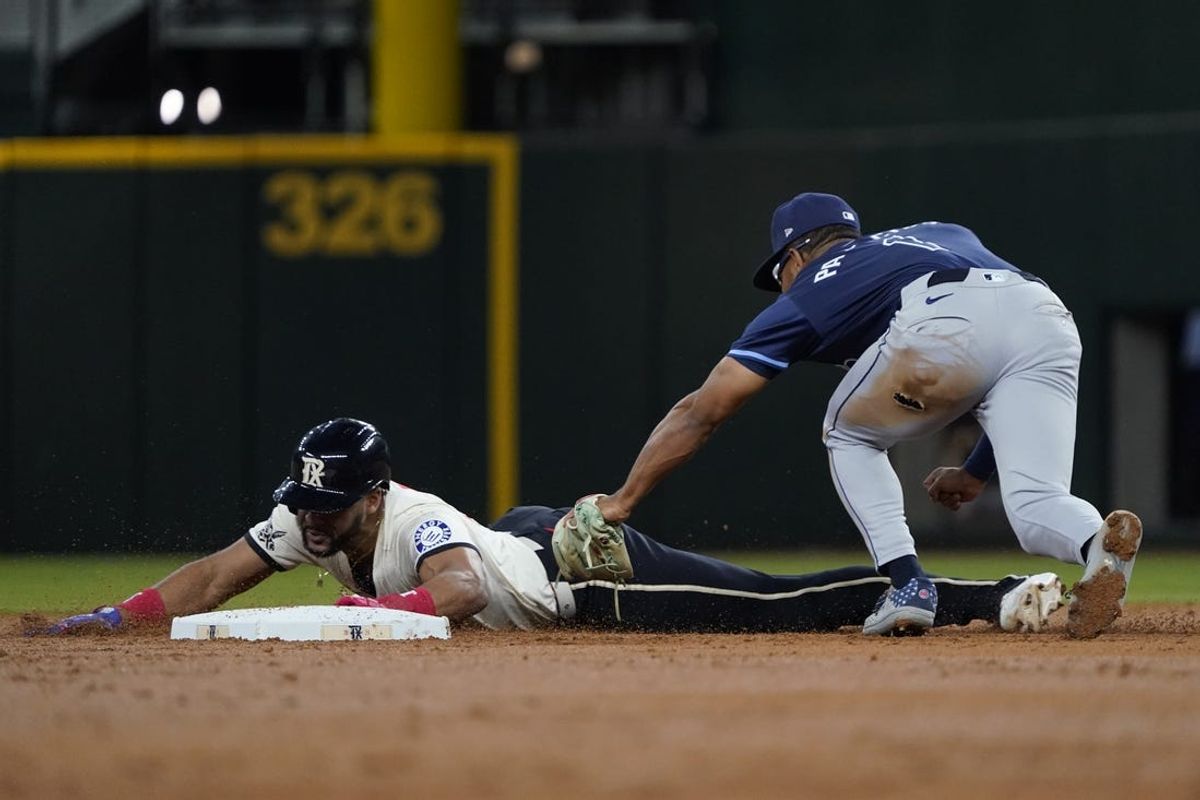 Jul 5, 2024; Arlington, Texas, USA; Texas Rangers outfielder Leody Taveras (3) is caught stealing second base as Tampa Bay Rays outfielder Richie Palacios (1) applies the tag during the third inning  at Globe Life Field. Mandatory Credit: Raymond Carlin III-USA TODAY Sports