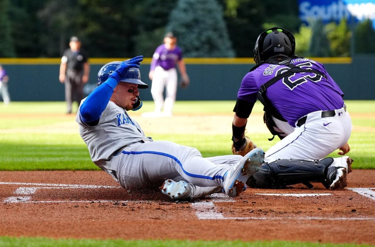 Jul 5, 2024; Denver, Colorado, USA; Kansas City Royals shortstop Bobby Witt Jr. (7) scores past Colorado Rockies catcher Jacob Stallings (25) in the first inning at Coors Field. Mandatory Credit: Ron Chenoy-USA TODAY Sports